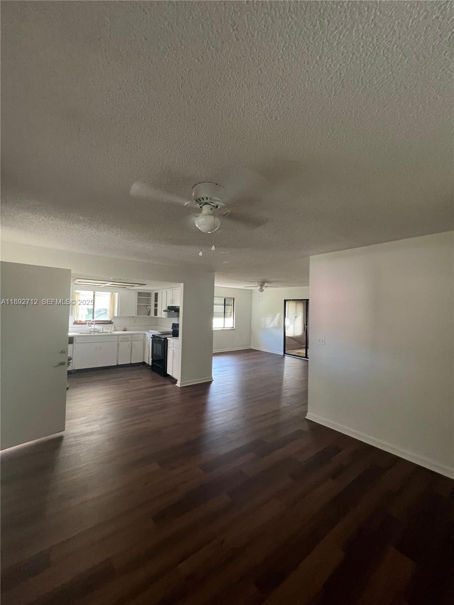8935 Southwest 104th Place Ocala, FL 34481 - Photo 13 of 21 a view of empty room with wooden floor and windows