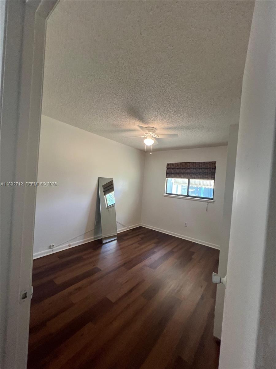 8935 Southwest 104th Place Ocala, FL 34481 - Photo 14 of 21 a view of an empty room and wooden floor