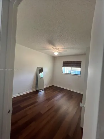 a view of an empty room and wooden floor