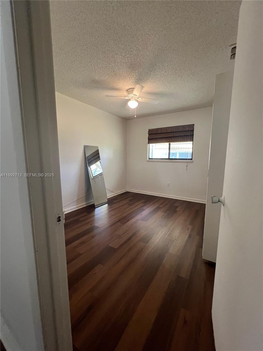 8935 Southwest 104th Place Ocala, FL 34481 - Photo 16 of 21 an empty room with wooden floor and windows