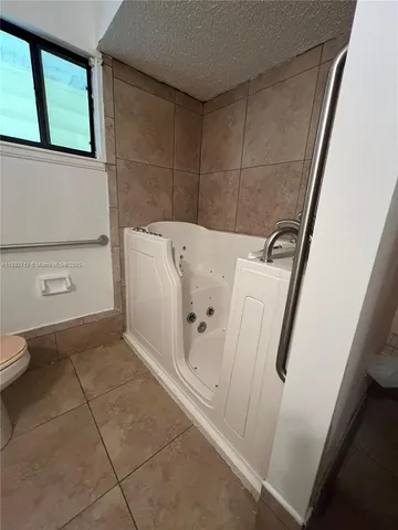 a bathroom with a bathtub and toilet