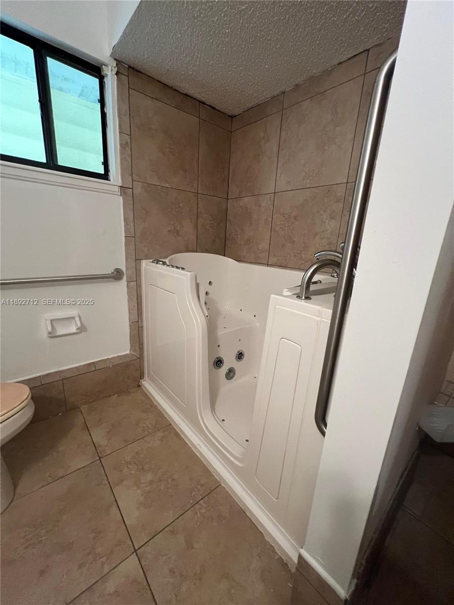 8935 Southwest 104th Place Ocala, FL 34481 - Photo 18 of 21 a bathroom with a bathtub and toilet