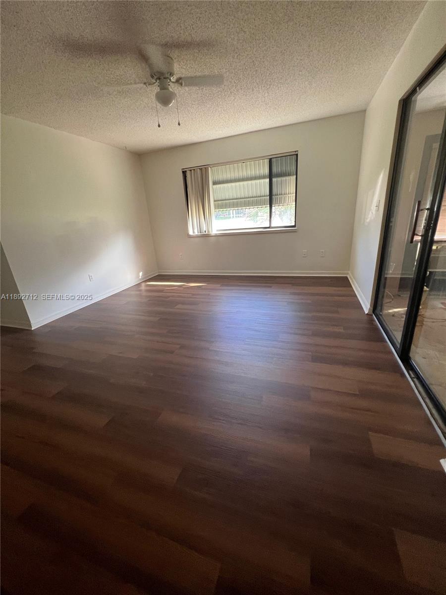 8935 Southwest 104th Place Ocala, FL 34481 - Photo 5 of 21 an empty room with wooden floor and windows