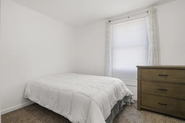 a bedroom with a bed and a mirror