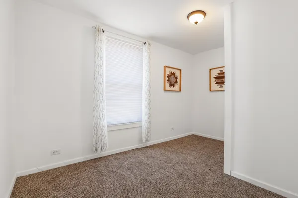 an empty room with wall painting and hallway
