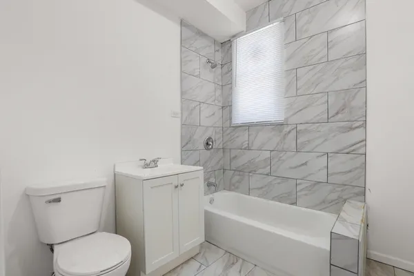a bathroom with a sink a toilet and bathtub
