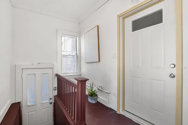 a view of a hallway with wooden shelves