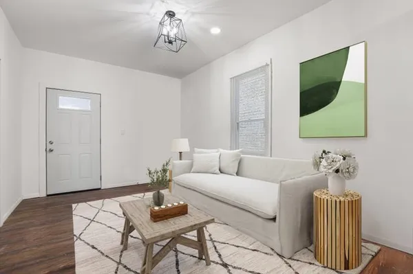 a living room with furniture and wooden floor