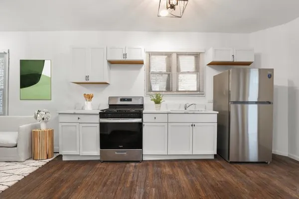 a kitchen with a refrigerator and a stove top oven