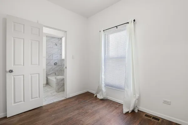 an empty room with wooden floor