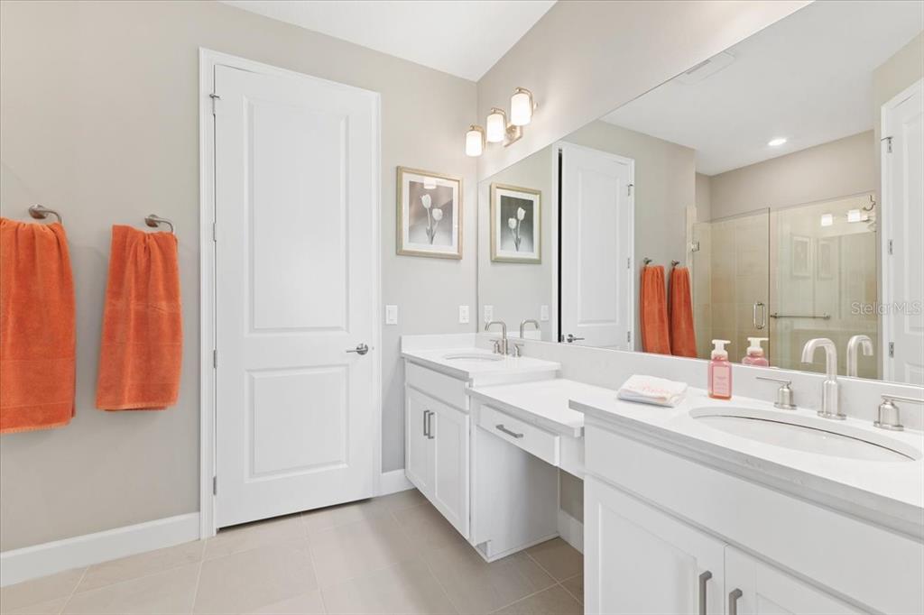 6236 Grandview Hill Court Bradenton, FL 34203 - Photo 8 of 16 a bathroom with a double vanity sink and a mirror