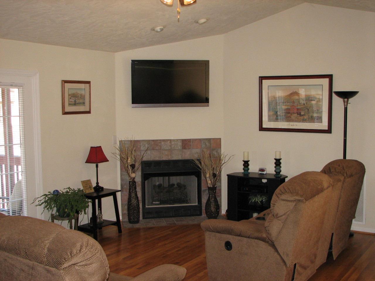 1715 Meadows Road Vinton, VA 24179 - Photo 6 of 37 a living room with furniture a flat screen tv and a fireplace