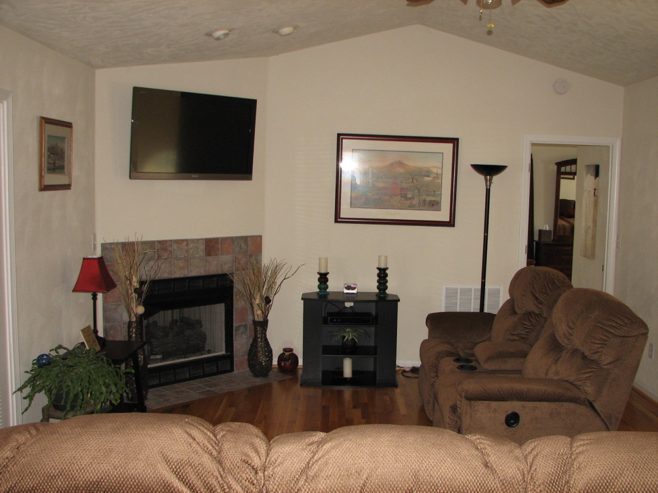 1715 Meadows Road Vinton, VA 24179 - Photo 7 of 37 a living room with furniture a flat screen tv and a fireplace