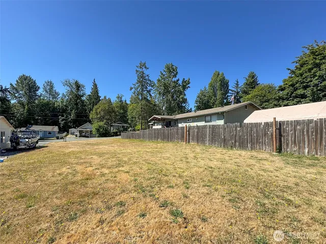 a view of backyard with swimming pool and outdoor space