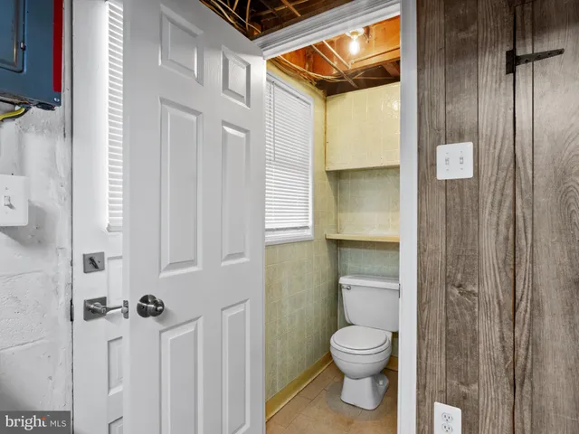 a bathroom with a granite countertop toilet a sink and shower