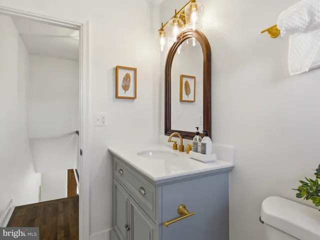 a bathroom with a sink mirror and vanity