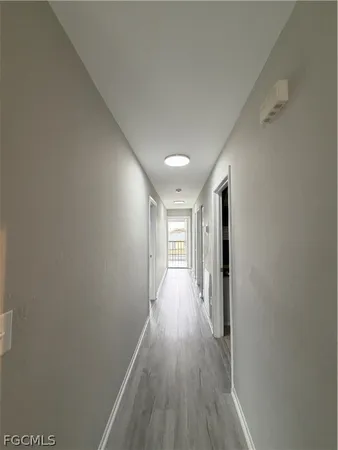 a view of a hallway with wooden floor
