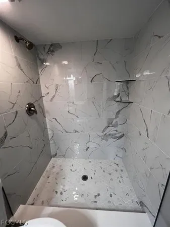 a bathroom with a bathtub and shower