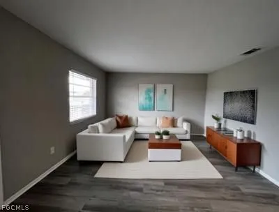 a living room with furniture and a flat screen tv