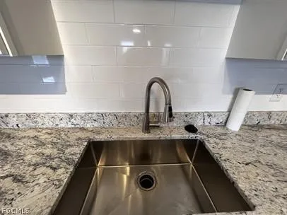 a close view of a sink and a stove in a kitchen