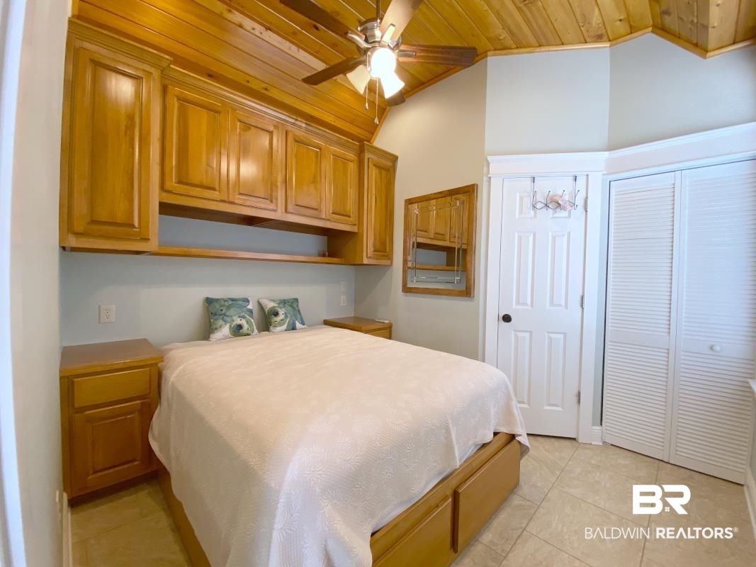 28888 Canal Road, Unit 71 Orange Beach, AL 36561 - Photo 6 of 9 Bedroom featuring lofted ceiling, light tile patterned floors, and wooden ceiling