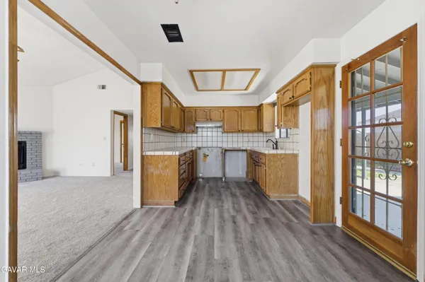 a kitchen with a refrigerator a sink and cabinets