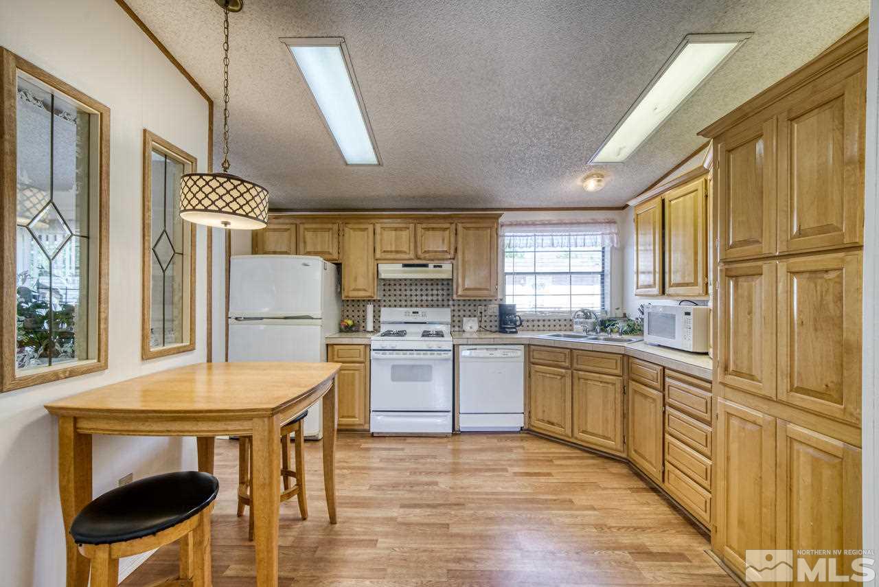 15030 Vega Street Reno, NV 89521 - Photo 12 of 29 a kitchen with cabinets and wooden floor