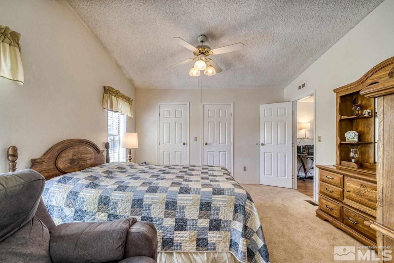 15030 Vega Street Reno, NV 89521 - Photo 14 of 29 a bedroom with a bed and dresser with mirror