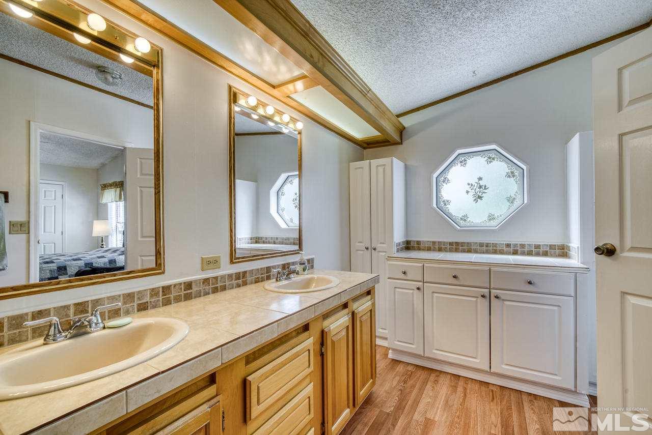 15030 Vega Street Reno, NV 89521 - Photo 18 of 29 a spacious bathroom with a granite countertop sink and a mirror