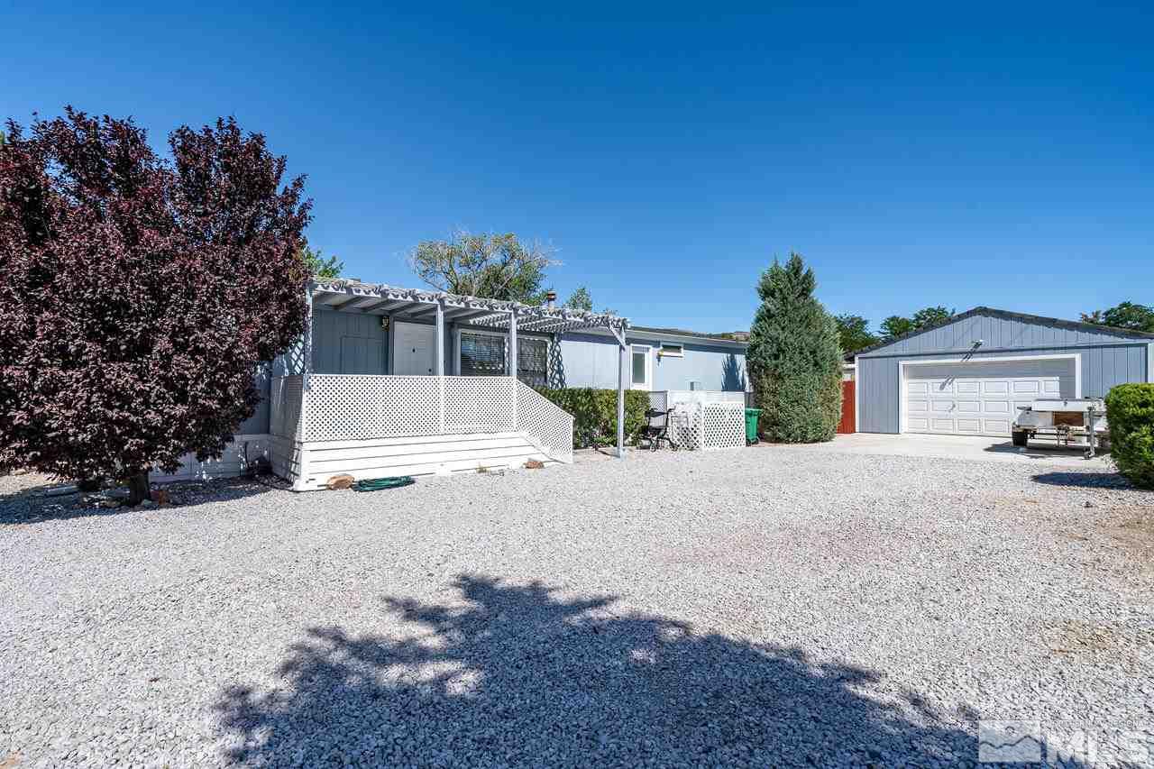15030 Vega Street Reno, NV 89521 - Photo 2 of 29 a front view of a house with a yard and garage