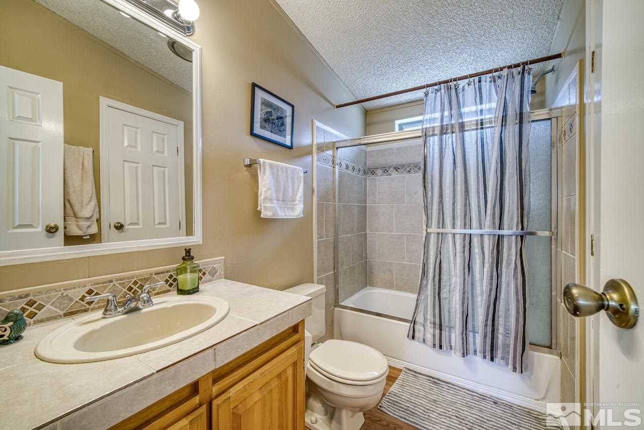 15030 Vega Street Reno, NV 89521 - Photo 21 of 29 a bathroom with a sink toilet and shower
