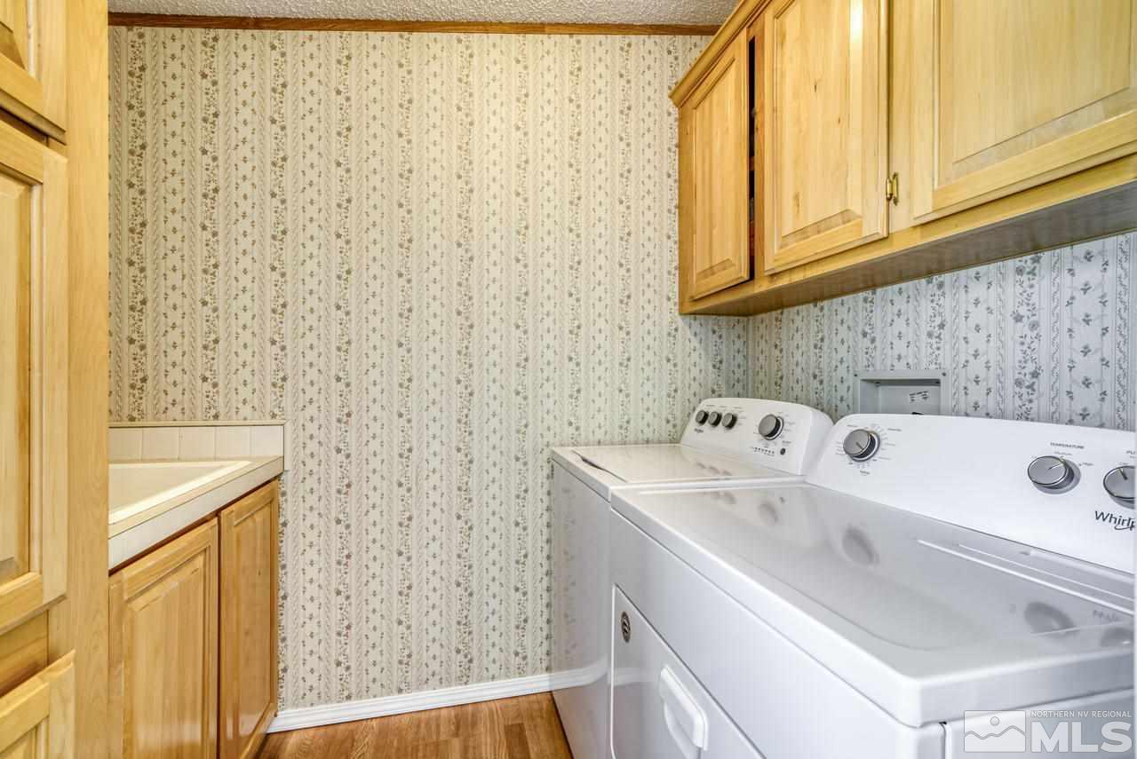 15030 Vega Street Reno, NV 89521 - Photo 22 of 29 a utility room with a sink a cabinetry and a window