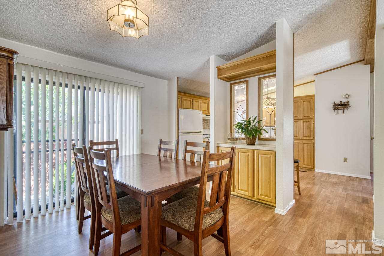15030 Vega Street Reno, NV 89521 - Photo 7 of 29 a view of a dining room with furniture and wooden floor
