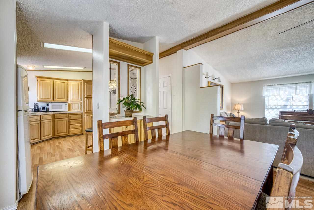 15030 Vega Street Reno, NV 89521 - Photo 9 of 29 a living room with furniture dining table and wooden floor