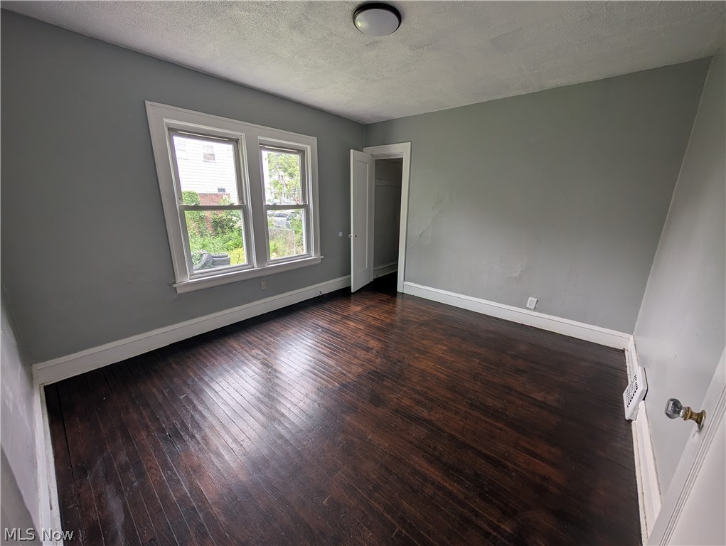 475 East 146th Street Cleveland, OH 44110 - Photo 12 of 28 Room featuring rich wood-finish flooring, light grey painted walls, and bright white trim