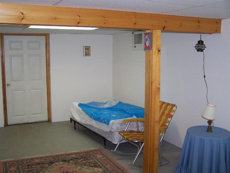 157 Compass Circle Hyannis, MA 02601 - Photo 18 of 21 a bedroom with a bed and wooden floor