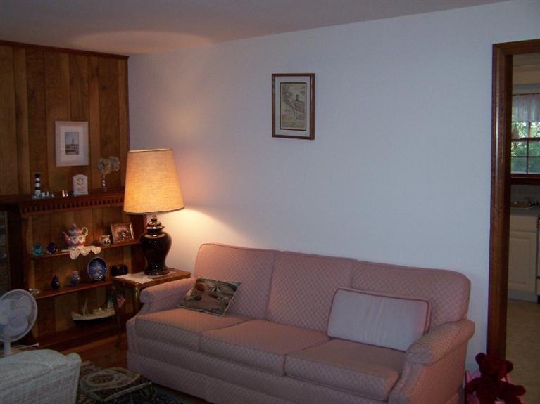 157 Compass Circle Hyannis, MA 02601 - Photo 8 of 21 a living room with furniture and a lamp