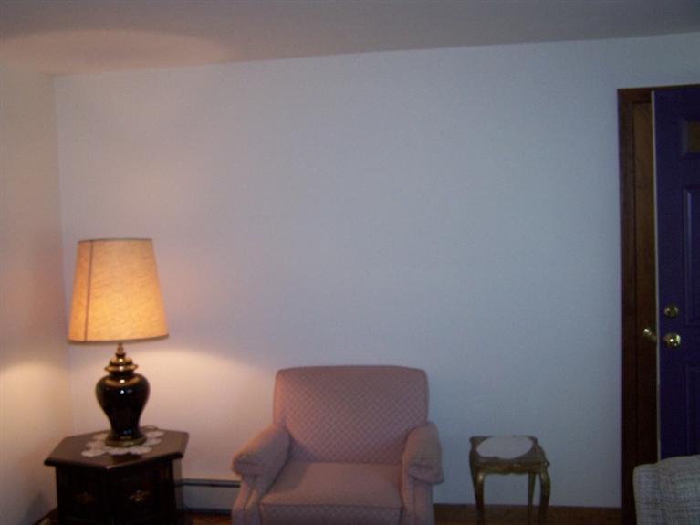 157 Compass Circle Hyannis, MA 02601 - Photo 9 of 21 a room with a table chair and a lamp