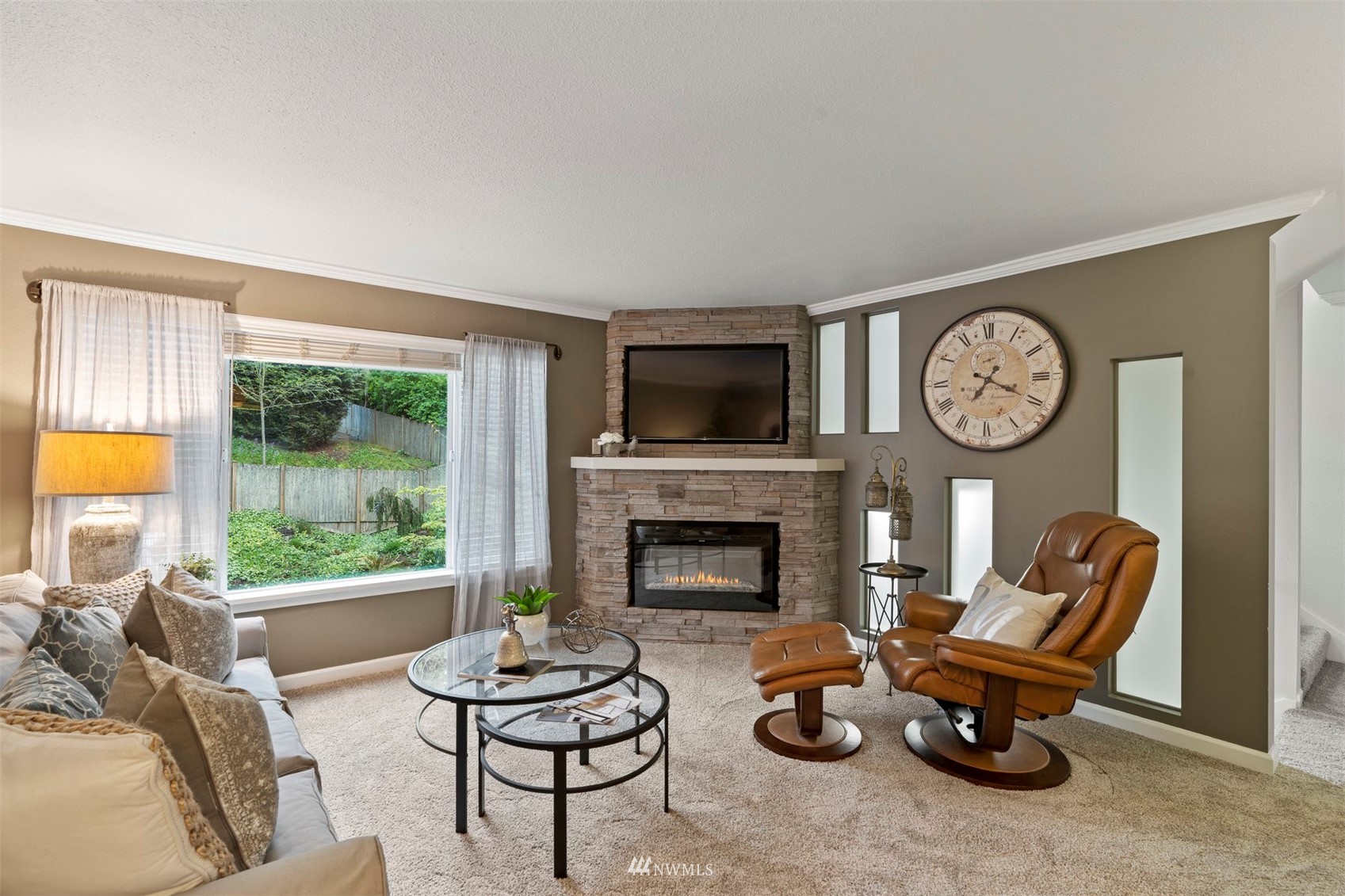 8806 Shell Place, Unit 100L Edmonds, WA 98026 - Photo 7 of 25 a living room with furniture a fireplace and a large window
