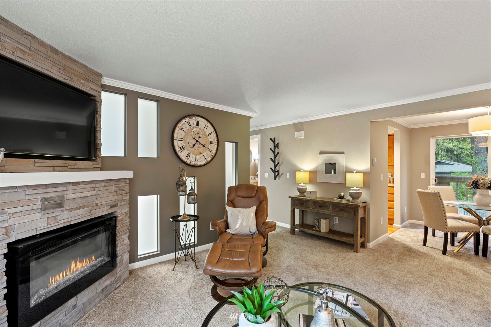 8806 Shell Place, Unit 100L Edmonds, WA 98026 - Photo 8 of 25 a living room with furniture a fireplace and a flat screen tv