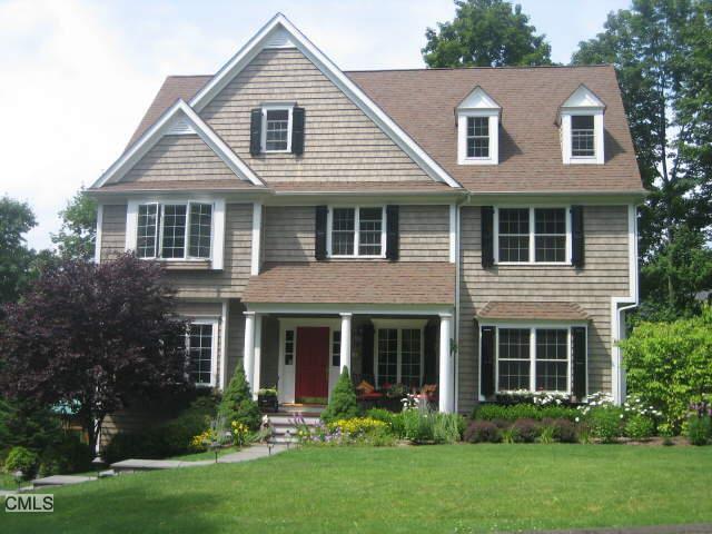 18 Mulvaney Court Ridgefield, CT 06877 - Photo 1 of 1 a front view of a house with a yard and trees
