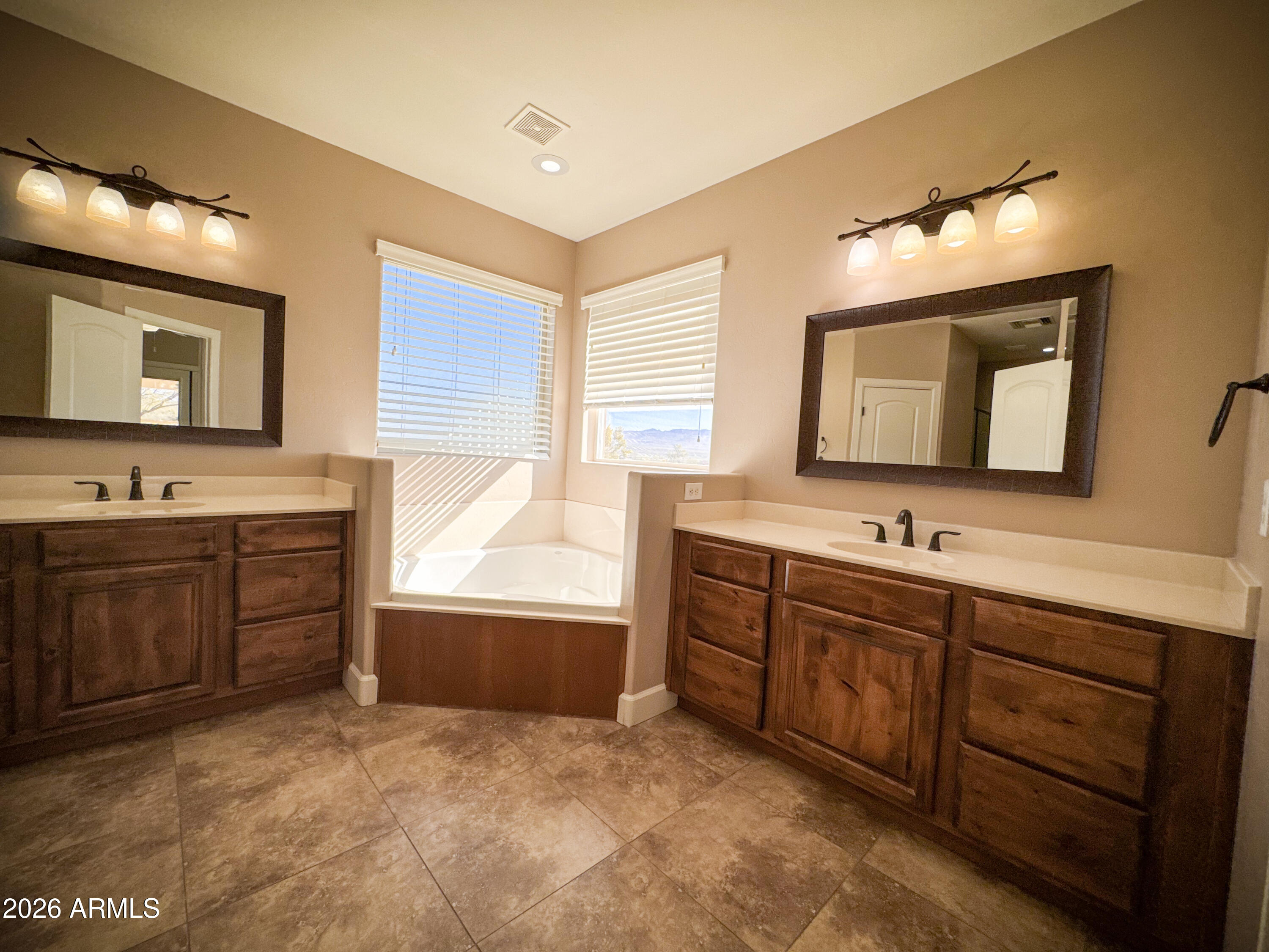 315 North 1720th Street West Pima, AZ 85543 - Photo 10 of 25 a bathroom with a sink mirror and a bathtub
