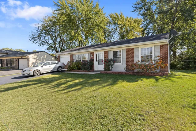 a swimming pool view with a seating space and a garden view