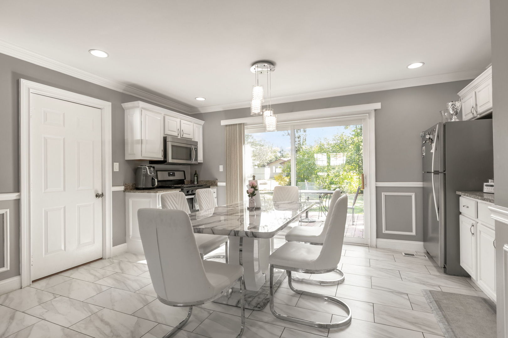 8181 Northway Drive Hanover Park, IL 60133 - Photo 11 of 23 a dining room with furniture a window and stainless steel appliances