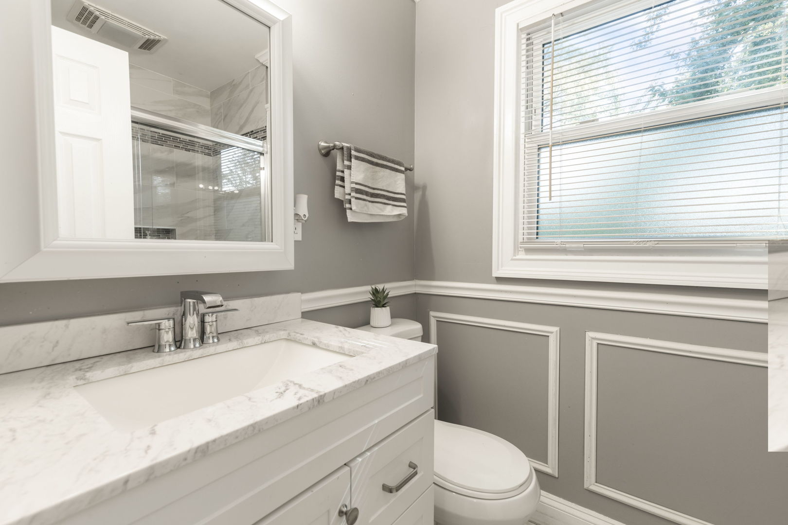 8181 Northway Drive Hanover Park, IL 60133 - Photo 13 of 23 a bathroom with a granite countertop toilet sink and mirror