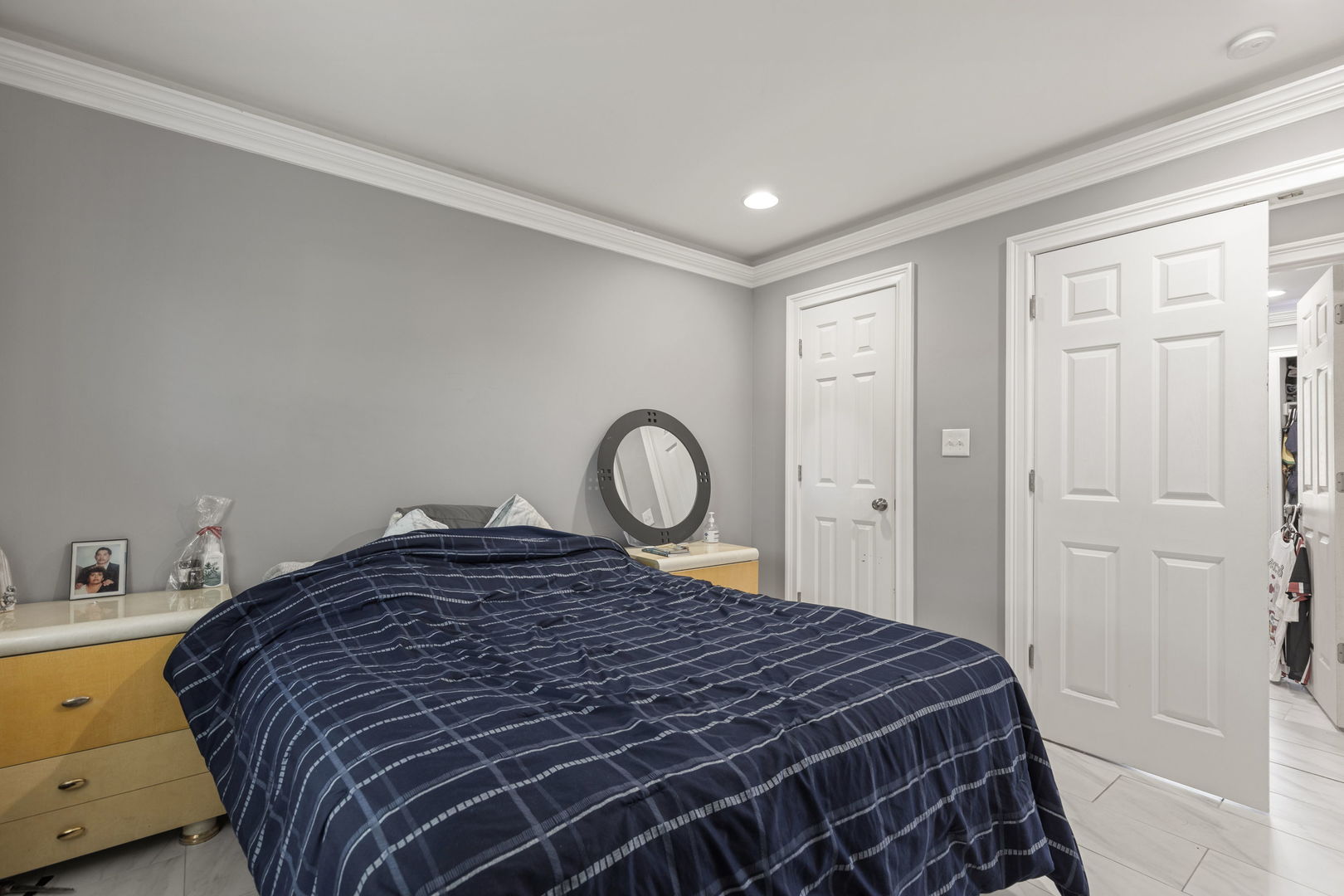 8181 Northway Drive Hanover Park, IL 60133 - Photo 15 of 23 a bed sitting in a bedroom next to a bathroom sink