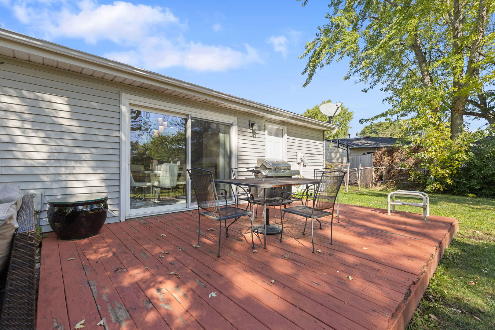 8181 Northway Drive Hanover Park, IL 60133 - Photo 16 of 23 a view of a patio with table and chairs with wooden floor and fence