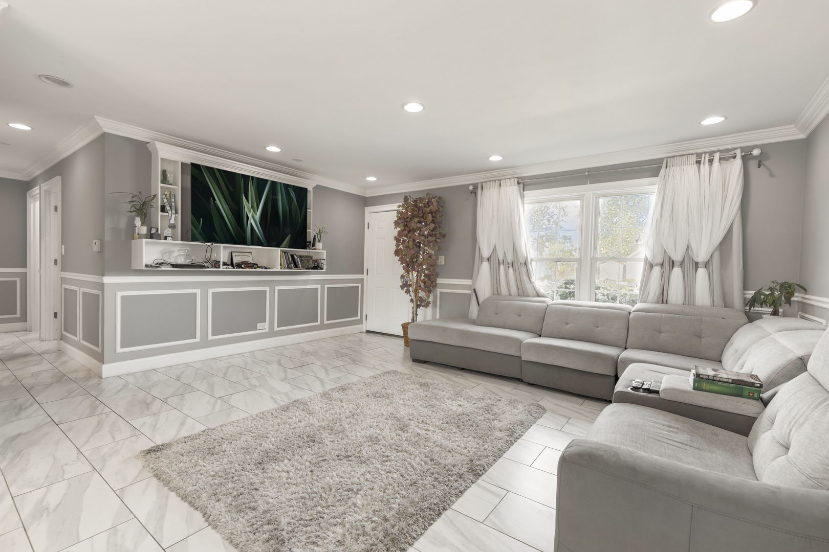 8181 Northway Drive Hanover Park, IL 60133 - Photo 5 of 23 a living room with furniture and a flat screen tv