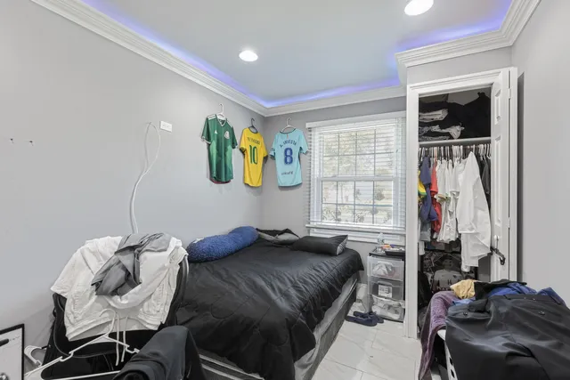 a bedroom with a bed and glass windows