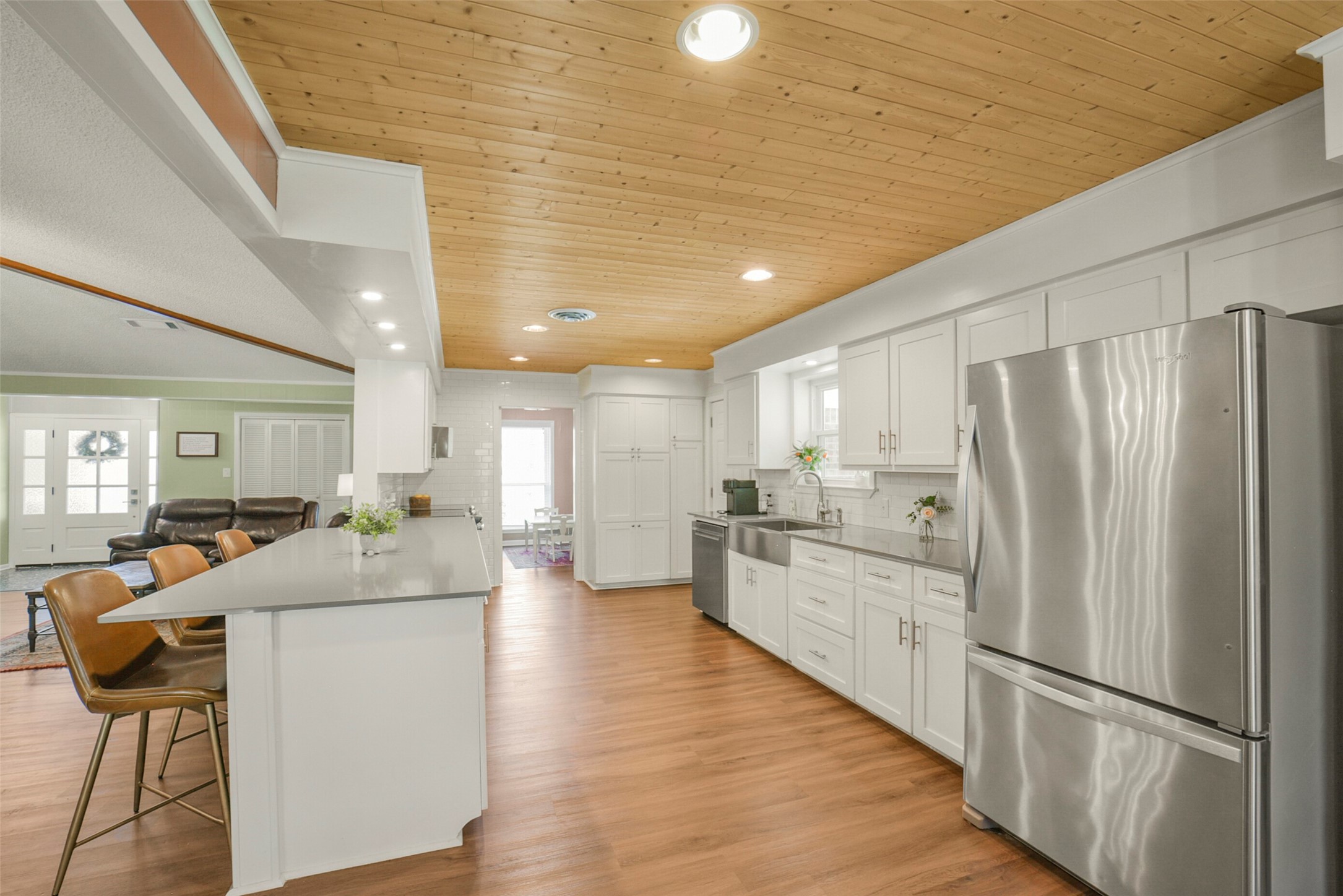 10313 South Williams Road Conroe, TX 77303 - Photo 12 of 48 Kitchen is light and bright with plenty of storage options. Wood paneled ceiling adds depth and charm.